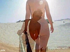 Mommy strips down to her bikini bottom on the public beach
